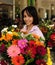 Woman with huge bouquet of flowers outdoors