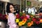 Woman with huge bouquet of flowers outdoors