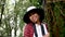 Woman hugging old tree gently with smile in the forest. Nature protection concept. World environment day.