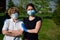 Woman hugs an elderly mother dressed in medical masks to protect against the virus. A pensioner and her adult daughter