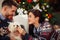 Woman with husband at home with cute dog celebrating Christmas e