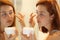Woman hydrating face skin applying moisturizer cream