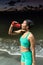 Woman hydrating during training at the beach