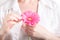 Woman hygiene conception. Pink flower gerbera in female hands