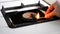 Woman ignites burner on the old gas stove wooden match
