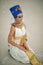 Woman in image of egyptian queen Nefertiti sits in desert