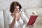 Woman with impaired vision reading a book through two glasses