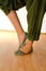 Woman Indian dance in national dress, slippers foot close up.