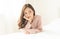 Woman indoor portrait. Closeup of pensive young Asain woman in warm knitted pink clothes in the bedroom. Negative human facial