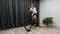 Woman on indoor smart trainer cycling drinks water or isotonic drink while riding a bicycle. Professional cycling training program