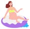 Woman on inflatable donut in water. Summer relaxation