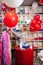 a woman inflates of helium from a big red balloon.