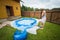 Woman inflates inflatable swimming pool