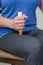 Woman injecting epinephrine into thigh