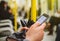 Woman insde metro train tube wagon using smartphone to see the m