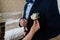 Woman inserting the boutonniere in buttonhole of man in suit