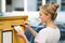 Woman Inserting Letter In Mailbox