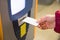 Woman inserting parking ticket into machine