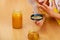 Woman inspecting honey with magnifying glass.