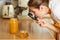 Woman inspecting honey with magnifying glass.