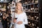 Woman inspecting quality of wine in wine store