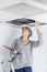 Woman inspecting roof space