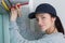 Woman installing cassette roller blinds on windows