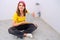 Woman installs floor tiles at home, DIY repair herself