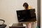 A woman installs a new TV on a table