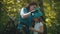 Woman instructor putting on a little girl protective helmet for the rope adventure