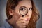 Woman investigator looking through magnifying glass