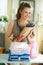 Woman with ironing board, clothes, softener and lavender