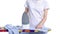 Woman ironing laundry blue shirt on iron board