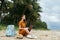 woman on the island sitting on the sand travel laptop work freelance