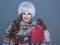 woman isolated on cold blue background showing small red shopping bag