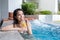 Woman in jacuzzi pool and enjoy drink