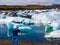 Woman in jeans photographs the landscape