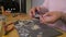 Woman - jeweler making jewellery in her workshop. Cutting silver ware with pliers