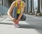 Woman jogger tying shoelaces on Pont de Bir-Hakeim bridge, Paris