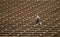 Woman jogging across bleacher seating Red Rocks Amphitheater in Morrison Colorado