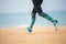 Woman is jogging along the seashore on an overcast day