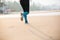 Woman is jogging along the seashore on an overcast day