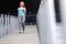 Woman jogging down on stairs. Legs workout at stadium, running on stairs. Fitness and health concept