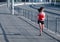 Woman jogging on empty highway