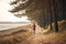 Woman jogging at the seaside. Female running by the sea. Active person. Cardio training. Physical fitness. Cardio workout. Healthy