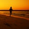 Woman jogging during Sunset over Jumeira beach in Dubai.