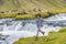 Woman joyful cheerful happy aspirational joyous smiling laughing having fun by waterfall on Iceland. Girl tourist in