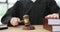 Woman judge beating with wooden gavel in law court