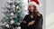 Woman judge in Santa Claus hat holds gavel and Christmas tree