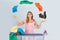 Woman Juggling With Clothes Near Ironing Board